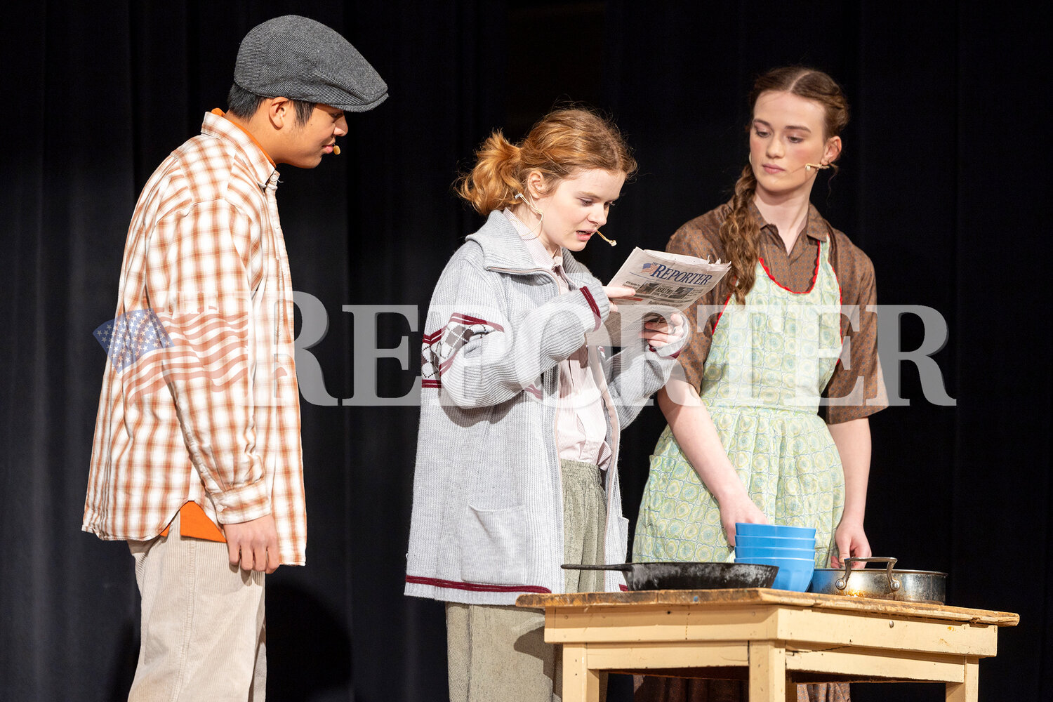 From left, Charlie Bucket played by David Gatchalian, and Mr. and Mrs. Bucket played by Kye Weil and Raegan Foster read the newspaper Saturday, March 23.